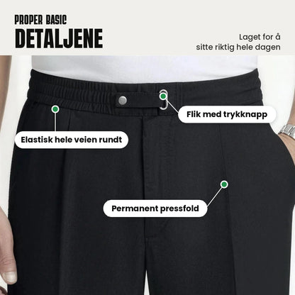 Detaljer: elastisk linning hele veien rundt, flik med trykknapp og permanent pressfold